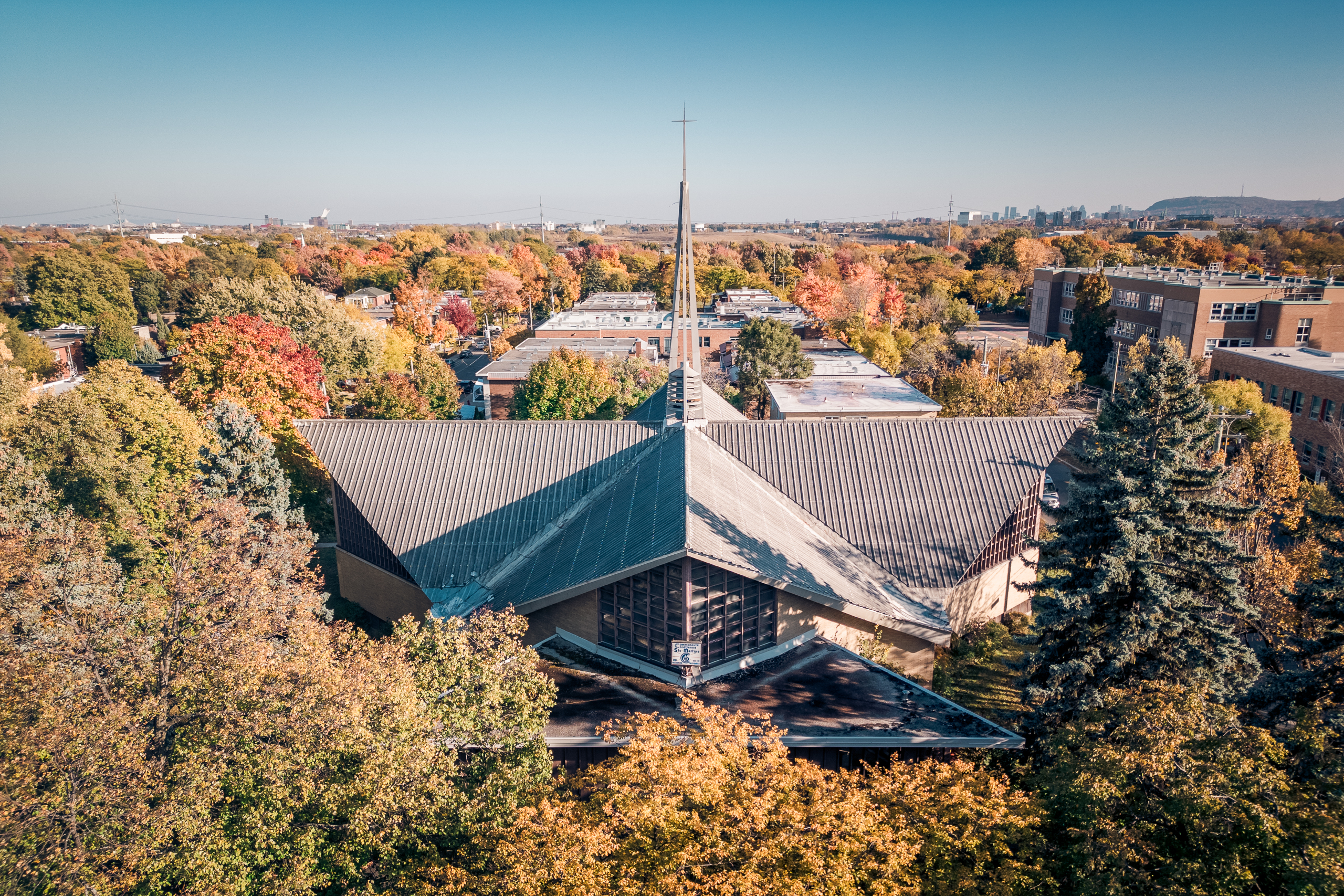 Église au toit pointu entourée de parcs aux couleurs d’automne, vue aérienne, Ahuntsic, Montréal