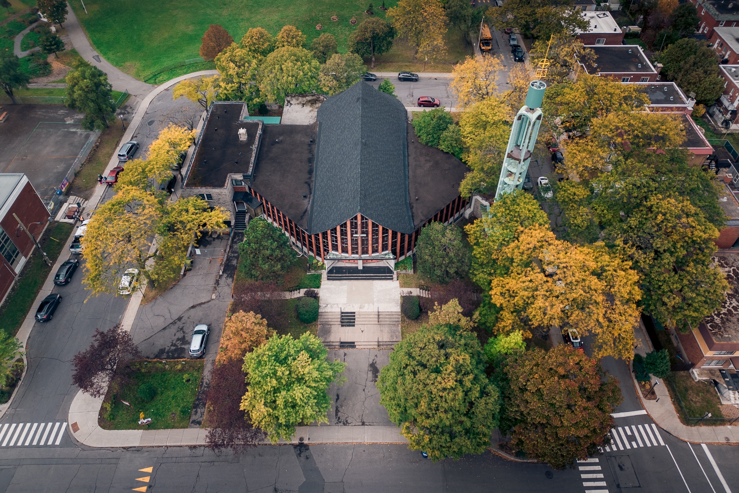 Église moderniste vue du dessus, entourée de rues et d’arbres d’automne, Ahuntsic, Montréal