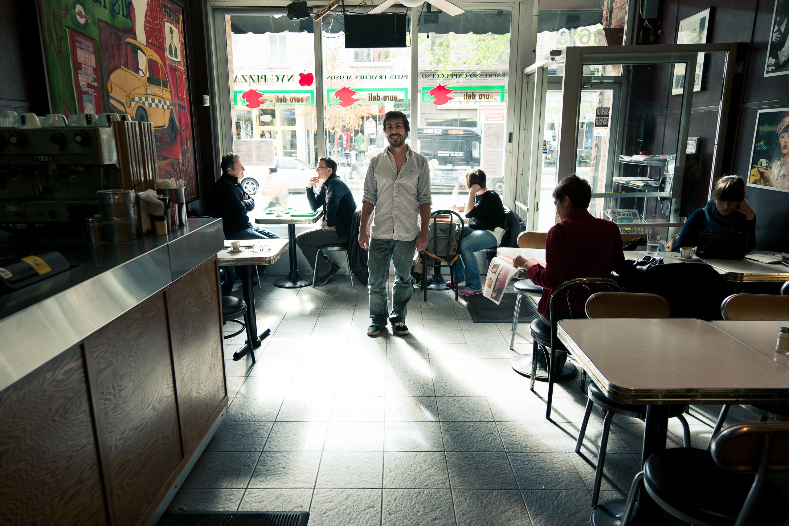 Portrait d’un ami debout dans un café, lumière de fenêtre
